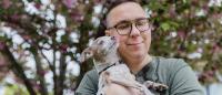 autistic adult holding a very sweet chihuahua